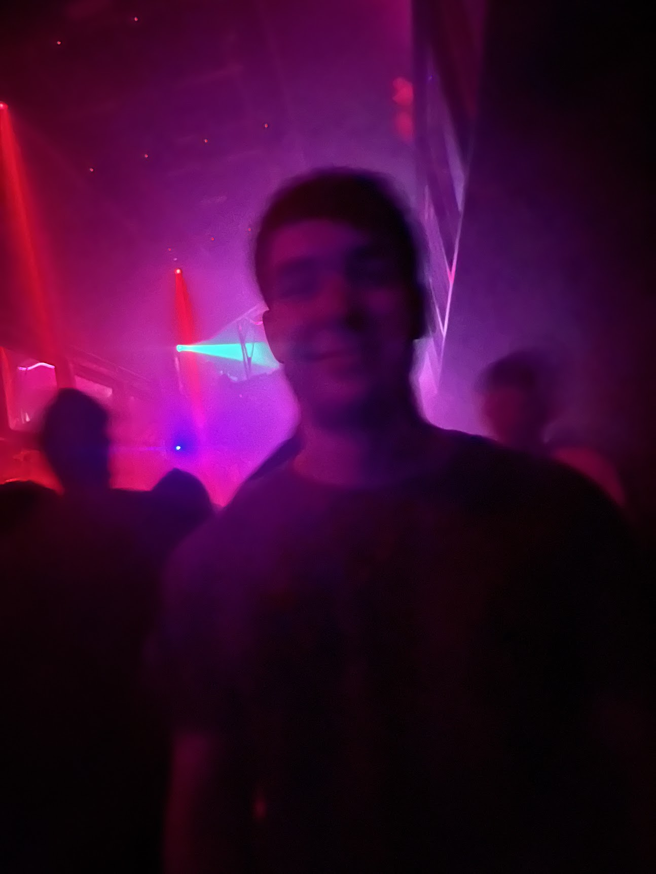 leaning on a neon lit bar counter